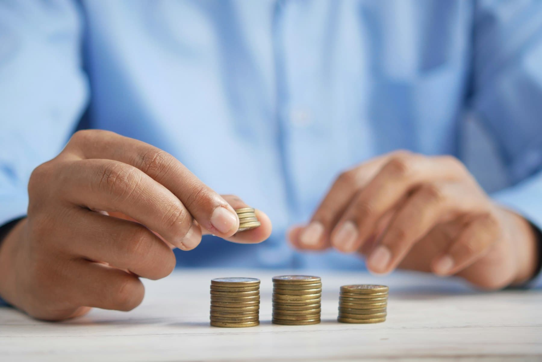 Stacking coins representing steady, predictable monthly rental income